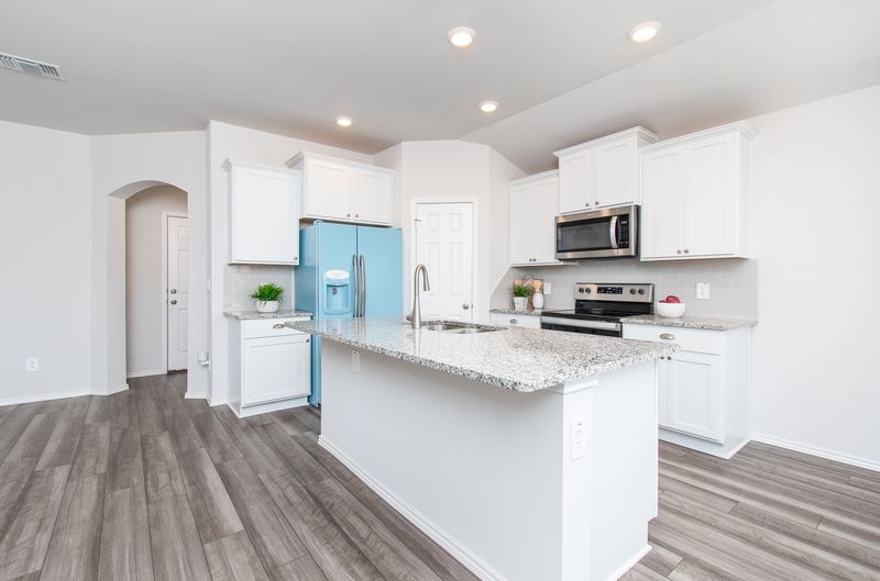 Bright kitchen with white cabinetry and an island