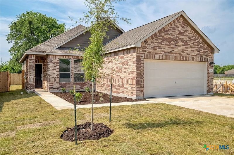 Brick home with a covered porch and garage