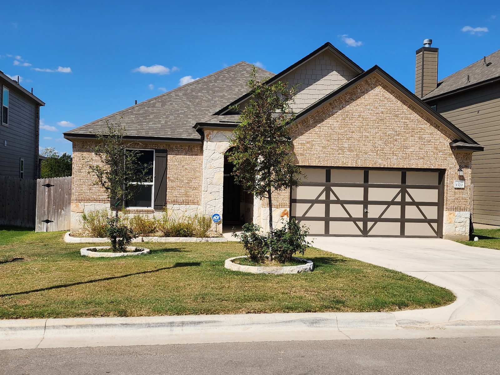 Stone-front home with a landscaped front yard