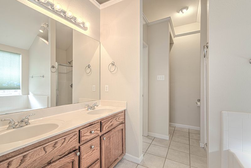 Double vanity and tiled bathroom