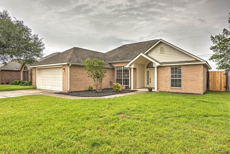 Brick home with a green front lawn