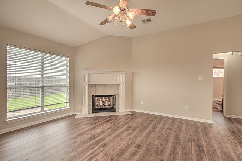 Living room with a fireplace and large windows